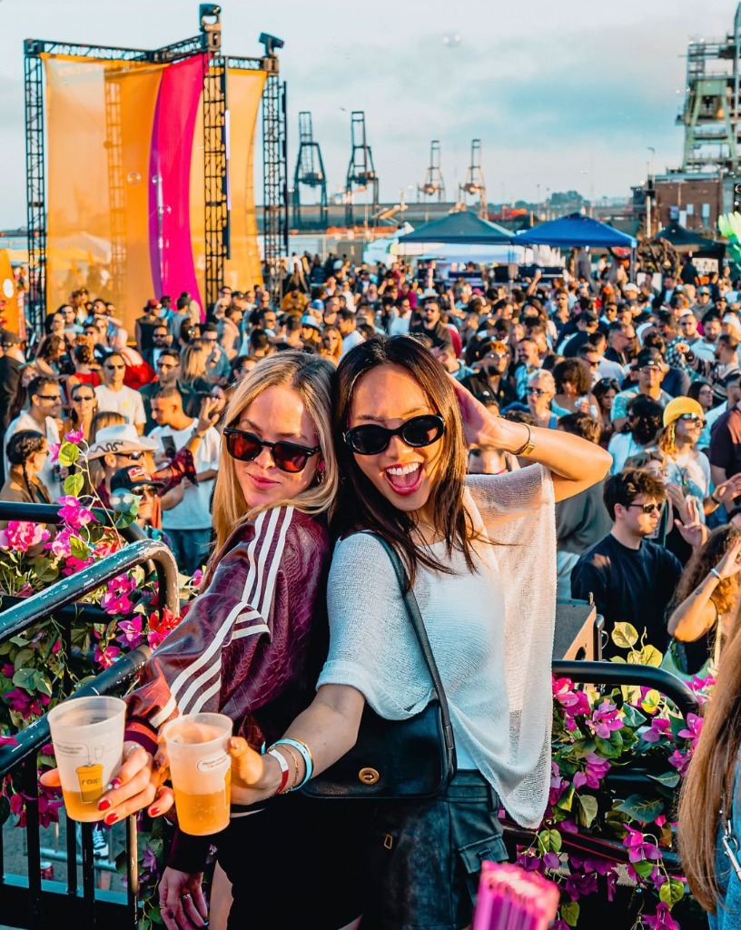 Concertgoers celebrating with reusable r.cup cups